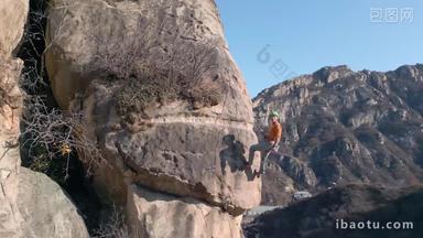 青年男人在悬崖峭壁上攀岩